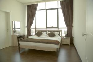 a bedroom with a bed and a large window at Rafa Homes in Riyadh
