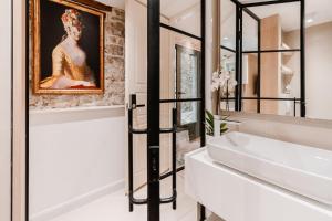 a bathroom with a sink and a mirror at Šibenik Palace in Šibenik +43 photos