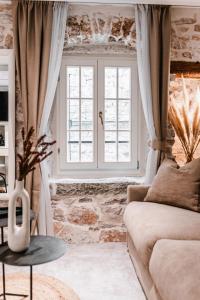 a living room with a couch and a window at Šibenik Palace in Šibenik