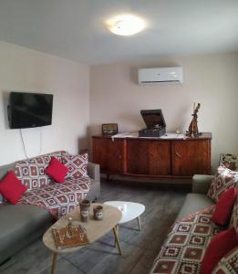 A television and/or entertainment centre at Chrisi Traditional House