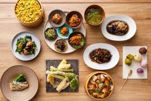 a table topped with plates of food and bowls of food at Via Inn Prime Akasaka in Tokyo