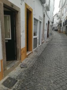 una calle adoquinada en una ciudad con edificios en The Sketchers House - Private Art Gallery, en Évora