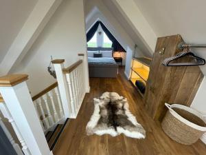 a dog laying on the floor in a room at Maple Cove in Rawtenstall