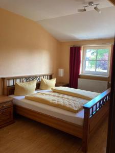 a bedroom with a large bed with a window at Dorfschule Mollseifen in Winterberg