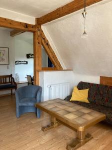 a living room with a couch and a table at Dorfschule Mollseifen in Winterberg