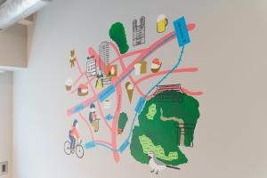 a wall mural of a map with people and attractions at ART HOTELS SHIBUYA in Tokyo