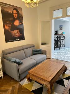 a living room with a couch and a coffee table at La petite place de la Porte d'Arras in Lille