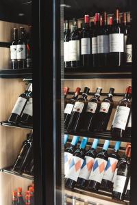 a refrigerator filled with lots of bottles of wine at Boutique Hotel Petit Montisión in Palma de Mallorca