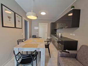 a kitchen and living room with a table and a couch at Sea 1 Spa&Wellness in Civitanova Marche