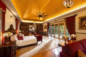 a bedroom with a bed and a living room at Coorg Wilderness Resort & Spa in Madikeri