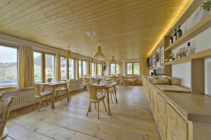 a restaurant with tables and chairs and windows at Chalet Speciale - Celerina in Celerina