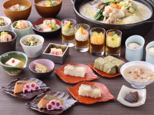 a table topped with plates of food and bowls of food at Hotel Nikko Nara in Nara