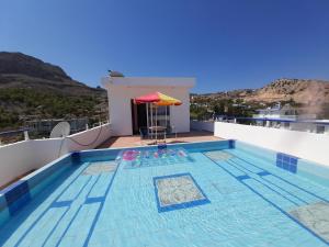 a swimming pool on the roof of a house at Exquisite Retreat For Two in Archangelos