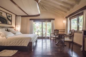 a bedroom with a bed and a desk and a table at Ocean Beach Resort & SPA in Malindi +63 photos
