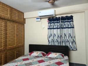 a bedroom with a bed and a window at ADVIK HOMESTAYS in Tirupati