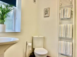 a bathroom with a toilet and a sink at Milecastle Inn on Hadrian's Wall near Haltwhistle in Haltwhistle +10 photos