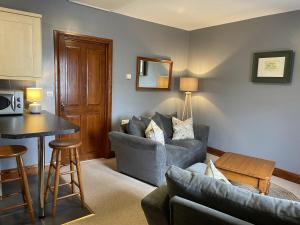 a living room with a couch and a table at Milecastle Inn on Hadrian's Wall near Haltwhistle in Haltwhistle