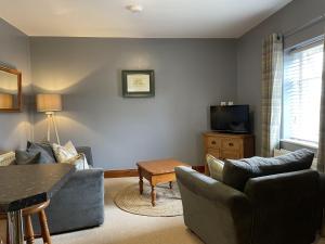 a living room with two couches and a tv at Milecastle Inn on Hadrian's Wall near Haltwhistle in Haltwhistle