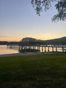 a dock on the water with a building in the background at Apartman 511 in Lipno nad Vltavou
