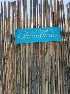 a blue sign on top of a wooden fence at Casa de Almano - Torremolinos direct on beach in Torremolinos