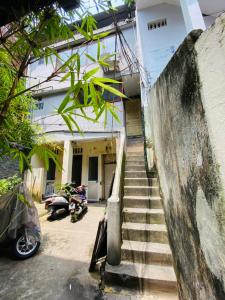uma escada que conduz a uma casa com uma moto em Wooden House 38 Hang Cot - 5' to HoanKiem Lake & Al Noor Mosque em Hanói
