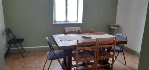 a dining room with a table and chairs at Maison pittoresque et cozy in Bonnat +10 photos
