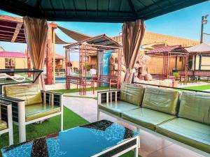 a patio with two benches and a playground at AlZaeem Resort & Hotels in Barka
