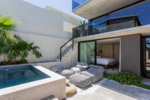 a house with a swimming pool and a bedroom at Villa Pietra - Camps Bay in Cape Town