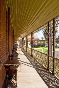a row of wooden benches sitting on a walkway at Hermitage Hill Country Retreat in Wellington +18 photos