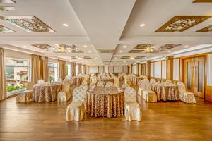 a banquet hall with tables and chairs in a room at Sterling Ooty Elk Hill in Ooty