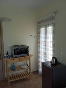 a microwave sitting on a table in a room at Leros 'Sundown' Guest house in Gourna