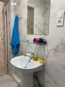 a white bathroom with a sink and a mirror at Елисаветинская 15 in Odesa