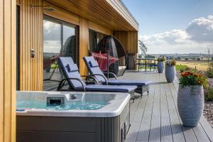 a hot tub on the deck of a house at The Hideaway Experience in Dundee