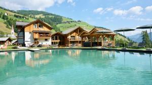 a large pool of water in front of a building at Chalet Mornà in San Martino in Badia