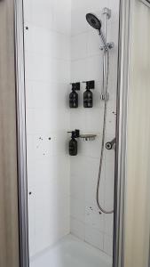 a bathroom with a shower with a shower head at Gioz87 in Gioz