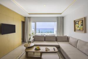 a living room with a couch and a table at Royal Azur Thalassa in Hammamet