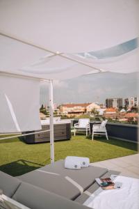 a white umbrella on top of a roof at Hotel Glory in Oradea