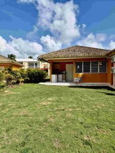 a house with a lawn in front of it at Manbana 333 in Folle Anse +5 photos