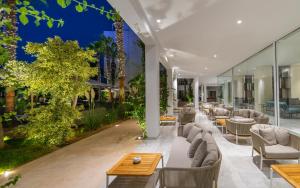 an outdoor patio with couches and tables at Royal Azur Thalassa in Hammamet