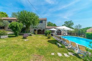 a house with a swimming pool and a yard at Villa Murva in Žminj