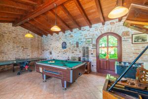 a room with a pool table and two ping pong tables at Villa Murva in Žminj