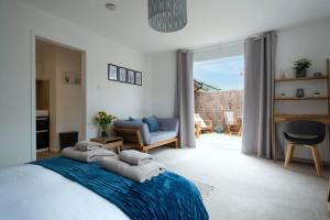 a bedroom with a bed with towels on it at Little Nye in Milford on Sea