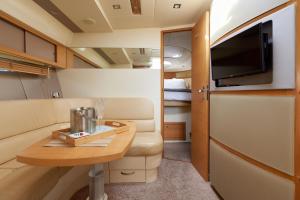 a small room with a table and a tv at Marli II in Lymington