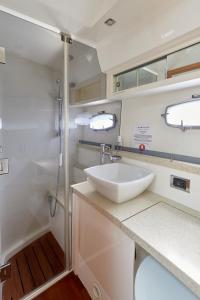 a bathroom with a sink and a shower at Marli II in Lymington +20 photos