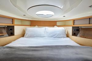 a bed in the center of a boat at Marli II in Lymington