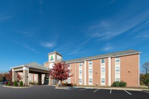 a large brick building with a clock tower at Holiday Inn Express Prince Frederick, an IHG Hotel in Prince Frederick