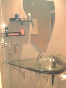 a glass sink in a bathroom with a mirror at Apartamentos Santiago - Maio in Vila do Maio
