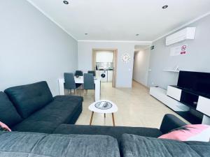 a living room with a couch and a table at PALM LIFE APARTMENT- Free Parking in Villareal