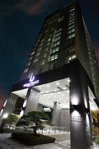 a tall building with a sign on it at night at Urban Place Gangnam in Seoul