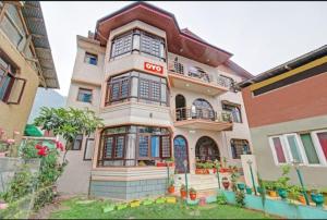 a house with a sign on the front of it at Tiramisu Inn By 29bungalow in Srinagar